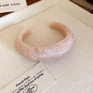 Detail view showing the elegant marbled texture of this pink resin open cuff bracelet.