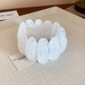 Detailed view of a white marbled resin stretch bracelet featuring large oval beads