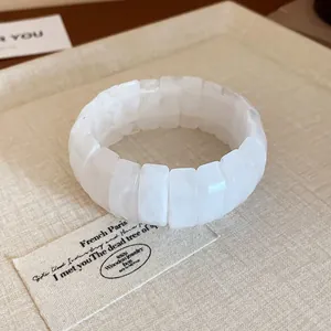 Minimalist white marbled texture segmented elastic bracelet shown on aesthetic tray