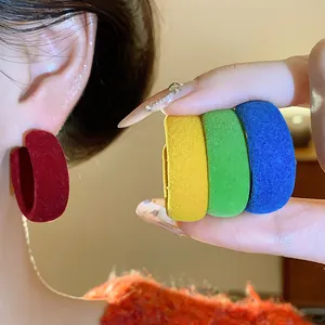 Close-up of colorful flocking hoop earrings showing velvet texture and vibrant hues