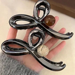 Minimalist gunmetal crossover shark hair clip with elegant marbleized sphere accent