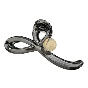 Elegant metallic gunmetal hair claw clip with cream marbled bead accent for women updos