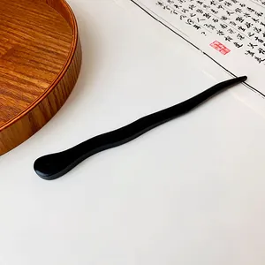 Elegant black wavy wooden hair stick for traditional Hanfu buns, detailed macro view