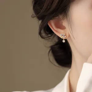 Detail view of cat earrings with 18k gold plating and colorful cubic zirconia stones