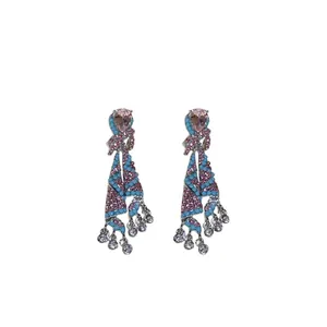 Ethnic style skirt-shaped earrings with pink and blue rhinestones on white background.