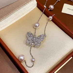 Elegant zircon butterfly pearl necklace for women shown in a luxury jewelry box