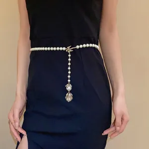 Elegant baroque pearl long necklace with golden bird charm used as a stylish waist chain belt