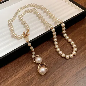 Elegant long baroque pearl necklace with vintage gold bird charm and double pendants