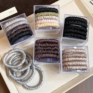 Detailed view of elegant fabric hair tie sets in earthy tones packed in acrylic gift boxes