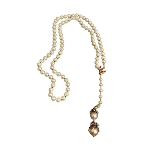 Elegant baroque pearl long necklace with bird charm and gold-toned crystal accents