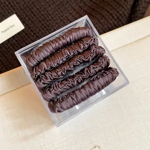 Set of 5 brown fabric elastic spring hair ties neatly packed in a clear storage box