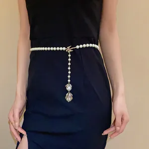 Elegant baroque pearl chain featuring a bird charm and pendant styled as a waist belt