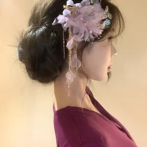 Elegant purple mesh flower hair clip with tassels and gold chains on model side profile