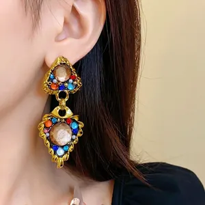 Elegant vintage style geometric drop earrings with colorful stones and a gold finish
