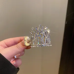 Detailed macro view of an elegant silver rhinestone crown hair claw with a heart-shaped grip