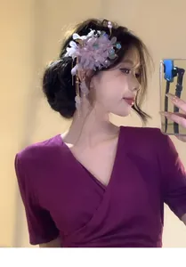 Detailed close-up view of sweet mori style mesh flower hair clip with tassels on model