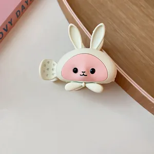 Detailed view of a cute cartoon bunny hair claw clip featuring a soft matte cream finish