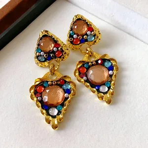 Vintage palace style gold heart-shaped earrings with colorful resin stones and pearls.