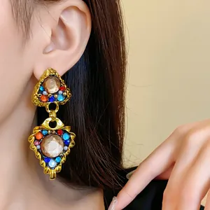Detailed view of vintage court-style drop earrings with colorful stones on model