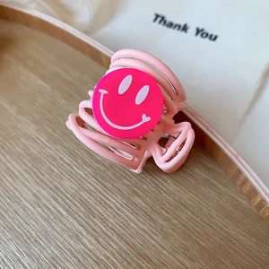 Detailed macro view of a cute pink smiley face hair claw clip accessory for stylish women