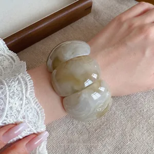 Chunky acrylic marbled square bracelet featuring an elegant white swirl pattern on a wrist