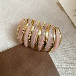 Fashionable pink marbled resin and gold-toned oval segmented open bangle bracelet