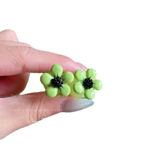Elegant small green resin flower stud earrings featuring a minimalist forest style design