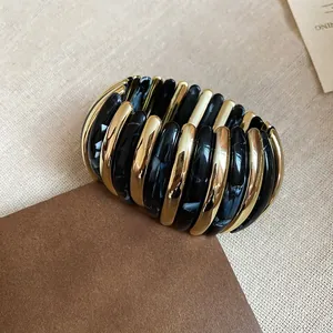 Fashionable marbled black and polished gold elliptical elastic bangle for minimalist style