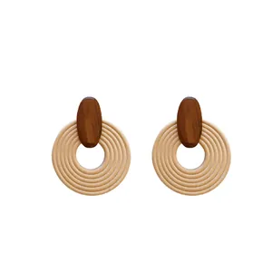 Bohemian retro style round spiral wooden earrings with silver needles on white background