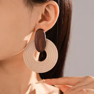 Detail view of bohemian spiral wood hoop earrings featuring a vintage ethnic design.