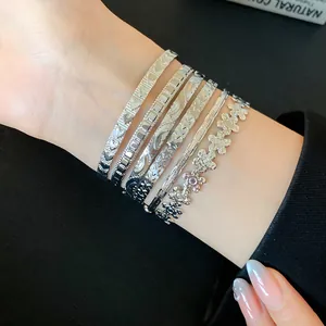 Detailed view of silver stackable cuff bracelets with heart, star and moon patterns