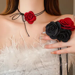 Detail showing elegant fabric rose choker and matching hand accessory with leather cord