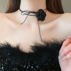 Close-up of a black fabric rose choker featuring a delicate leather braided cord design