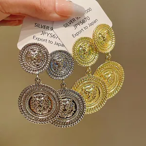 Detailed view of exquisite round lion head earrings featuring elegant S925 silver needles.