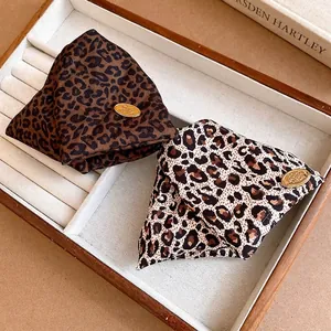 Elegant leopard print triangular hair clips in vintage fabric style for sophisticated hair styling