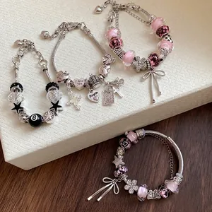 Set of four sweet rhinestone glass bead charm bracelets with flower and bow pendants