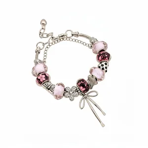 Elegant charm bracelet with pink glass beads and sparkling rhinestone flower bow pendant