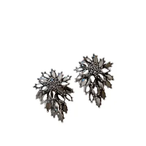 Vintage style floral tassel earrings with dark grey rhinestones on white background.