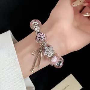 Detailed view of sweet style bracelet featuring pink glass beads and a rhinestone flower