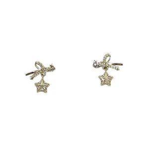 Elegant gold bow and star stud earrings with sparkling zirconia stones