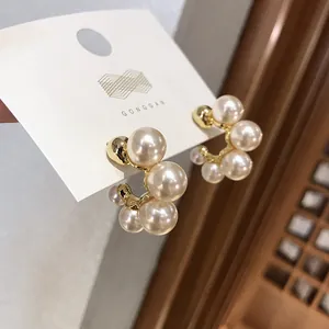 Elegant S925 silver needle pearl hoop earrings in gold finish on a white display card