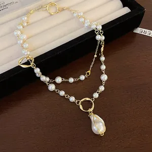 Detail showing double-layer pearl necklace with baroque pendant on jewelry tray