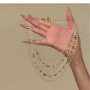 Detailed view of French vintage multi-layer pearl necklace with colorful gemstones