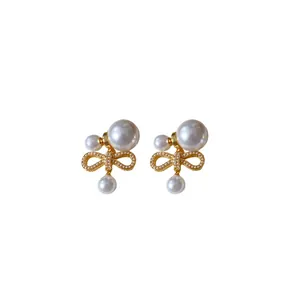 Eleganti orecchini a fiocco placcati oro con perle artificiali e perni in argento S925