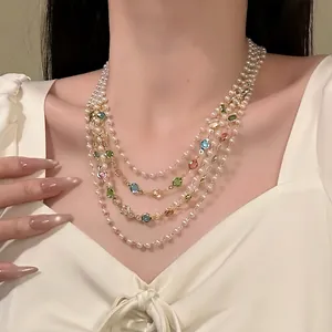 Detailed view of French vintage multi-layered pearl necklace with colorful gems