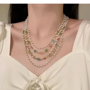 Elegant detail of a vintage French multi-layer pearl necklace with colorful gems