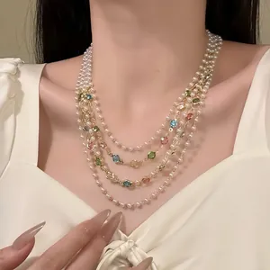 Elegant multi-layered pearl necklace with colorful gemstone beads on a female model