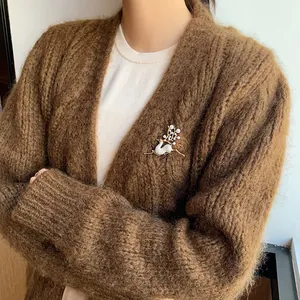 Detail of an elegant vintage deer brooch with pearls and crystals on a sweater