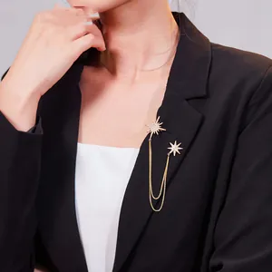 Close-up view of elegant vintage gold star tassel brooch pinned on a black blazer