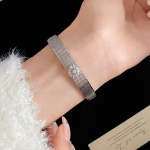 Detailed shot of a silver-plated mesh bracelet featuring a zircon flower on a wrist